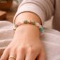 Love and connection gemstone bracelet worn on the wrist with rose quartz, amazonite, and green aventurine beads