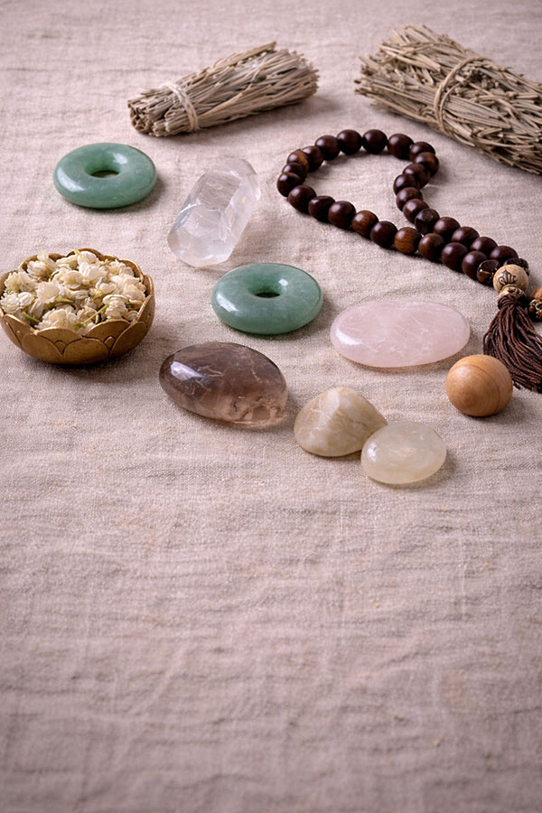 Symbolic materials including jade, crystal, wood, stone, and herbs used in Eastern Story creations