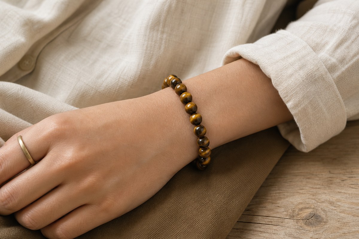 Tiger eye bracelet styled with neutral clothing and simple everyday accessories