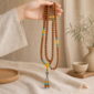 Bright Horizon 108-Bead Bodhi Seed Mala, mala draped naturally from one hand