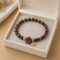 Deep Blossom Rosewood Bracelet, product in a neutral open display box