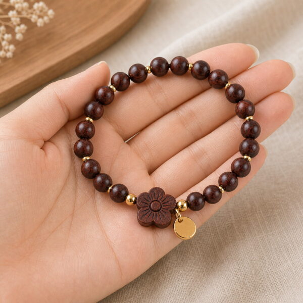 Deep Blossom Rosewood Bracelet - Handheld Deep Blossom Rosewood Bracelet, product held naturally in one hand