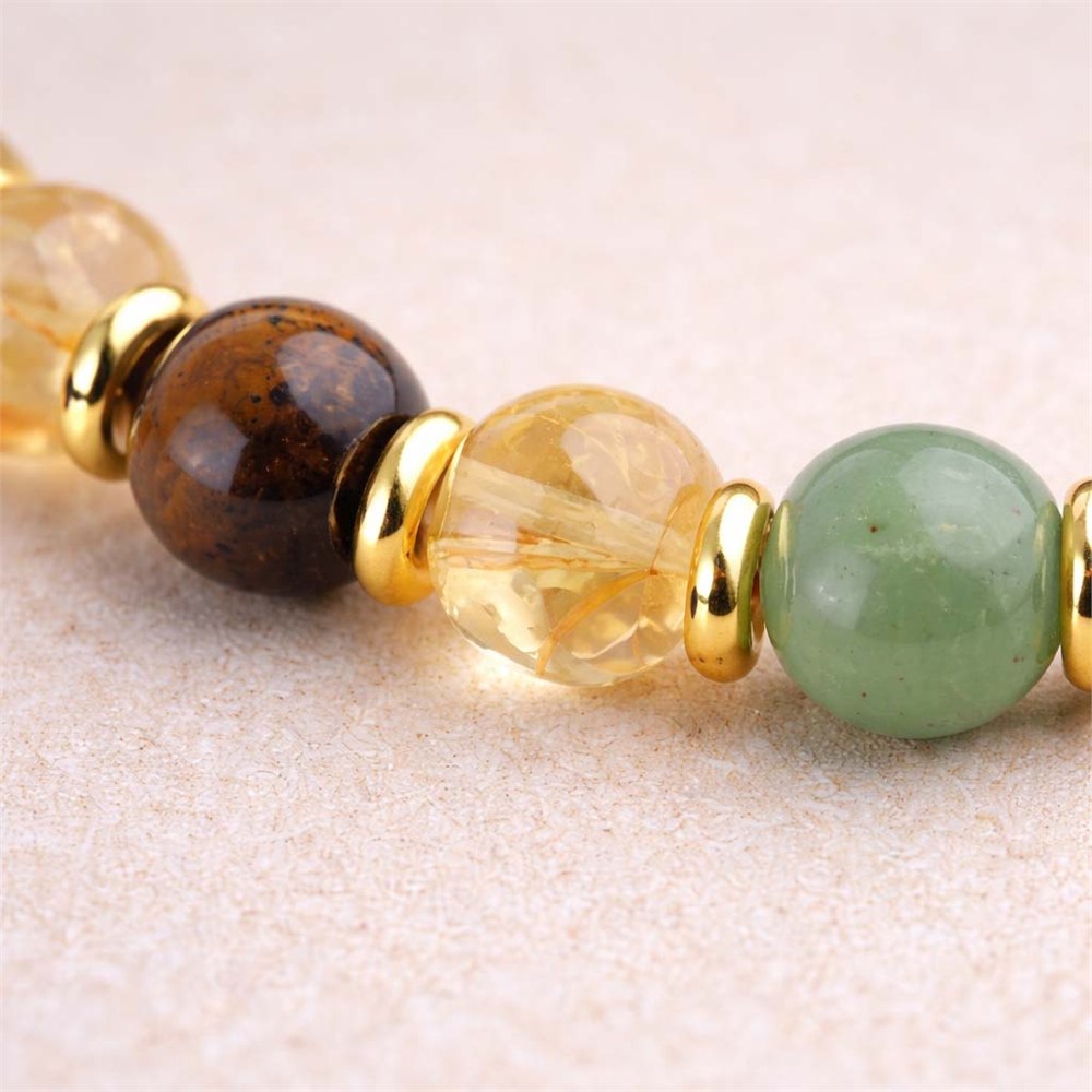Texture detail of green, golden, and earthy gemstone beads on the Good Fortune Balance bracelet