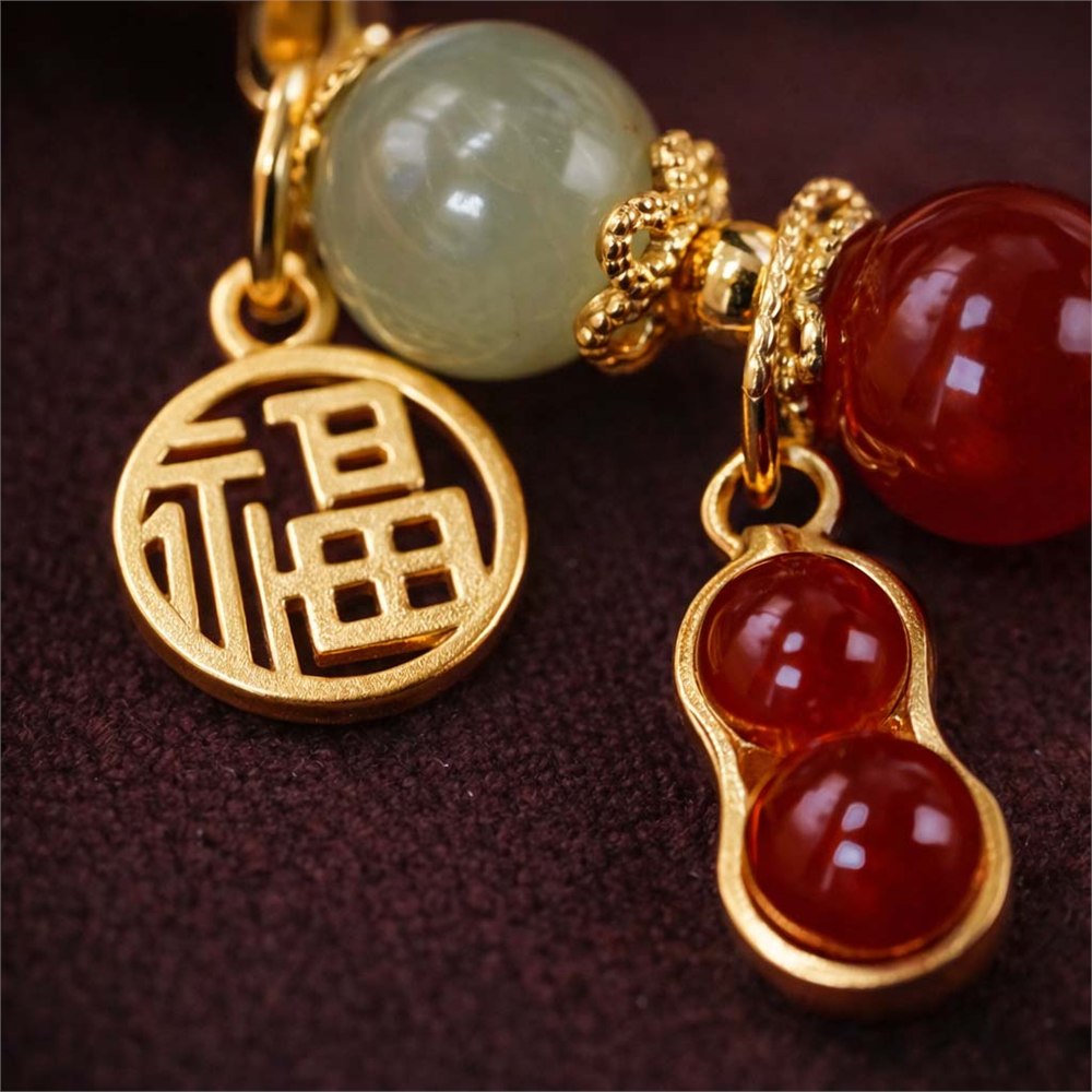 Texture detail of jade, red stone, and gold-toned beads on the Harmonized Fortune bracelet