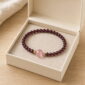 Gentle Ember Garnet & Pink Quartz Bracelet, product in a neutral open display box