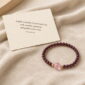 Gentle Ember Garnet & Pink Quartz Bracelet, product on premium textile with a meaning card