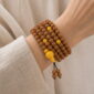 Golden Harvest 108-Bead Bodhi Seed Mala, faceless multi-wrap wrist view