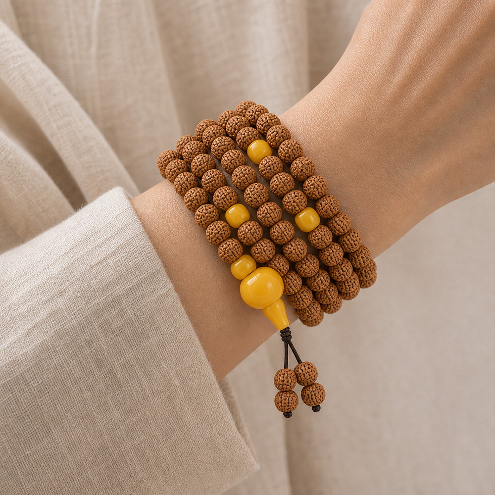 Golden Harvest 108-Bead Bodhi Seed Mala, faceless multi-wrap wrist view