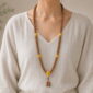 Golden Harvest 108-Bead Bodhi Seed Mala, faceless long-necklace view from collarbone to waist