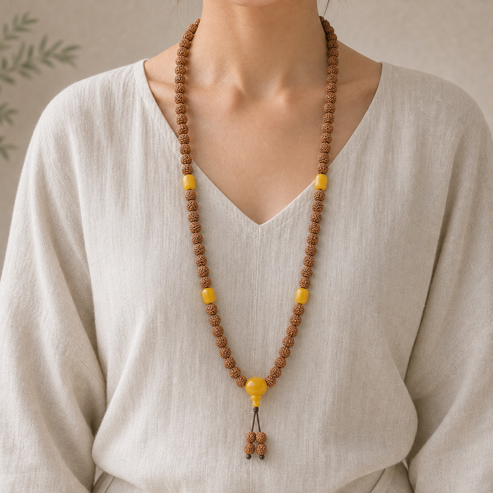 Golden Harvest 108-Bead Bodhi Seed Mala, faceless long-necklace view from collarbone to waist