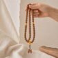 Golden Harvest 108-Bead Bodhi Seed Mala, mala draped naturally from one hand