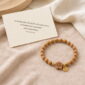 Peach Blossom Sandalwood Bracelet, product on premium textile with a meaning card