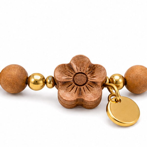 Peach Blossom Sandalwood Bracelet - Detail Peach Blossom Sandalwood Bracelet, close detail of beads, centerpiece, cord, and drop