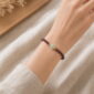 Quiet Glow Garnet & Pale Stone Bracelet, faceless natural wrist wearing the product