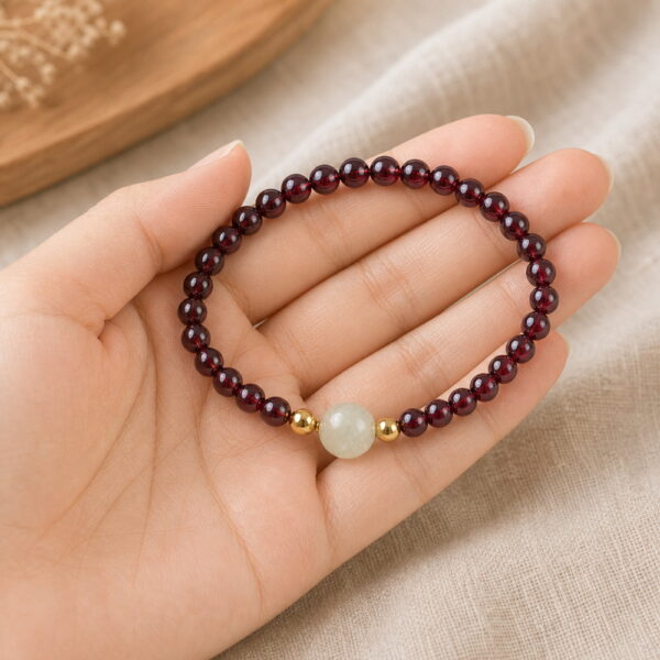 Quiet Glow Garnet & Pale Stone Bracelet - Handheld Quiet Glow Garnet & Pale Stone Bracelet, product held naturally in one hand