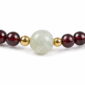 Quiet Glow Garnet & Pale Stone Bracelet, close detail of beads, centerpiece, cord, and drop