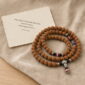 Rising Sun 108-Bead Bodhi Seed Mala, mala on premium textile with a meaning card