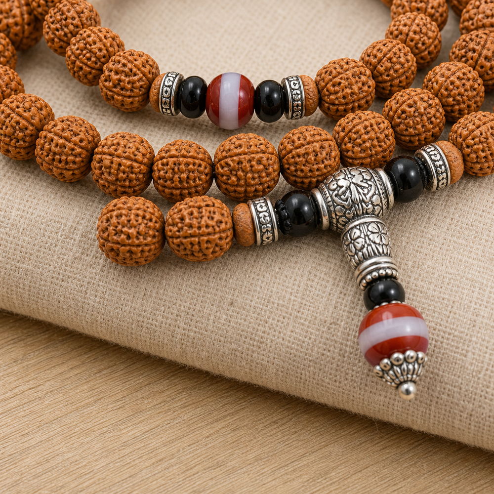 Rising Sun 108-Bead Bodhi Seed Mala, close detail of seed texture, accent beads, connector, and drop