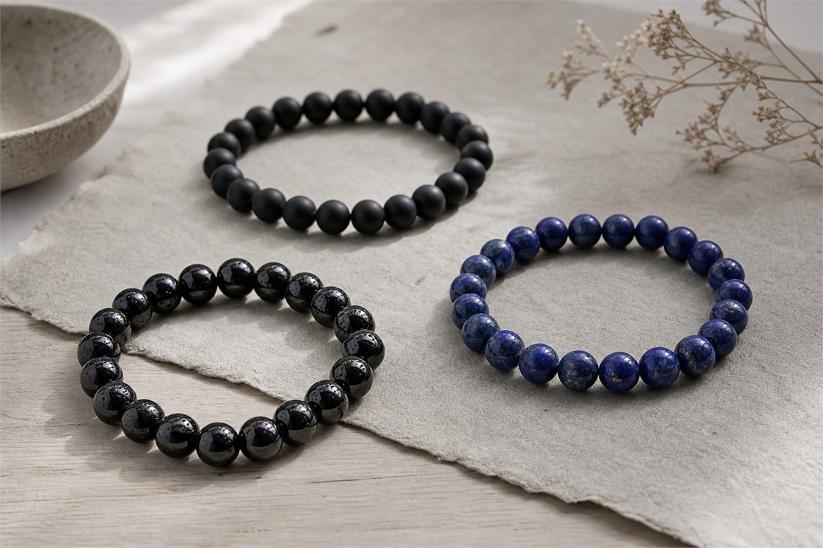 Glossy black obsidian, matte black agate, and deep blue lapis lazuli bracelets