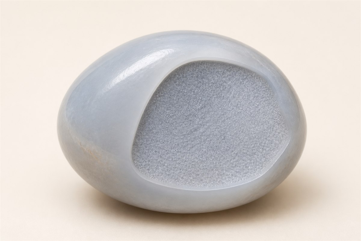 Cutaway pale blue chalcedony pebble showing a dense ultra-fine internal texture