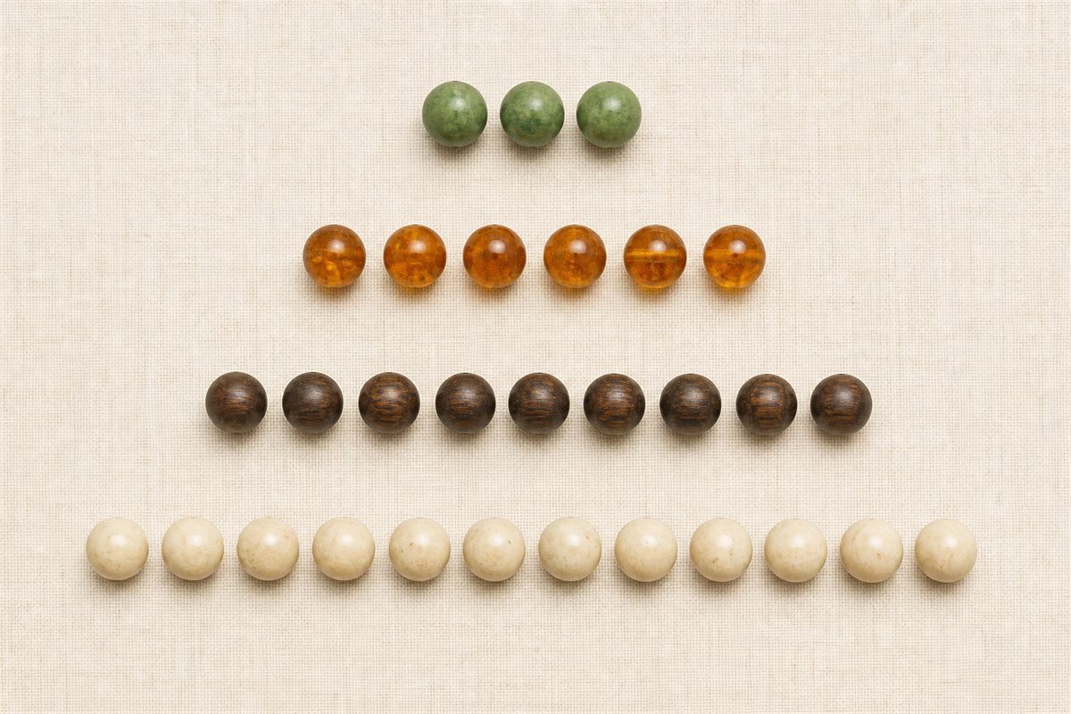 Four separate rows containing exactly 3, 6, 9, and 12 wooden beads
