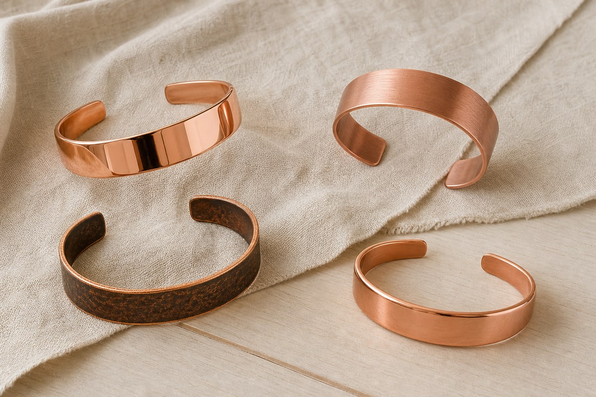 Four red copper cuffs with polished, brushed, antiqued, and clear coated surfaces
