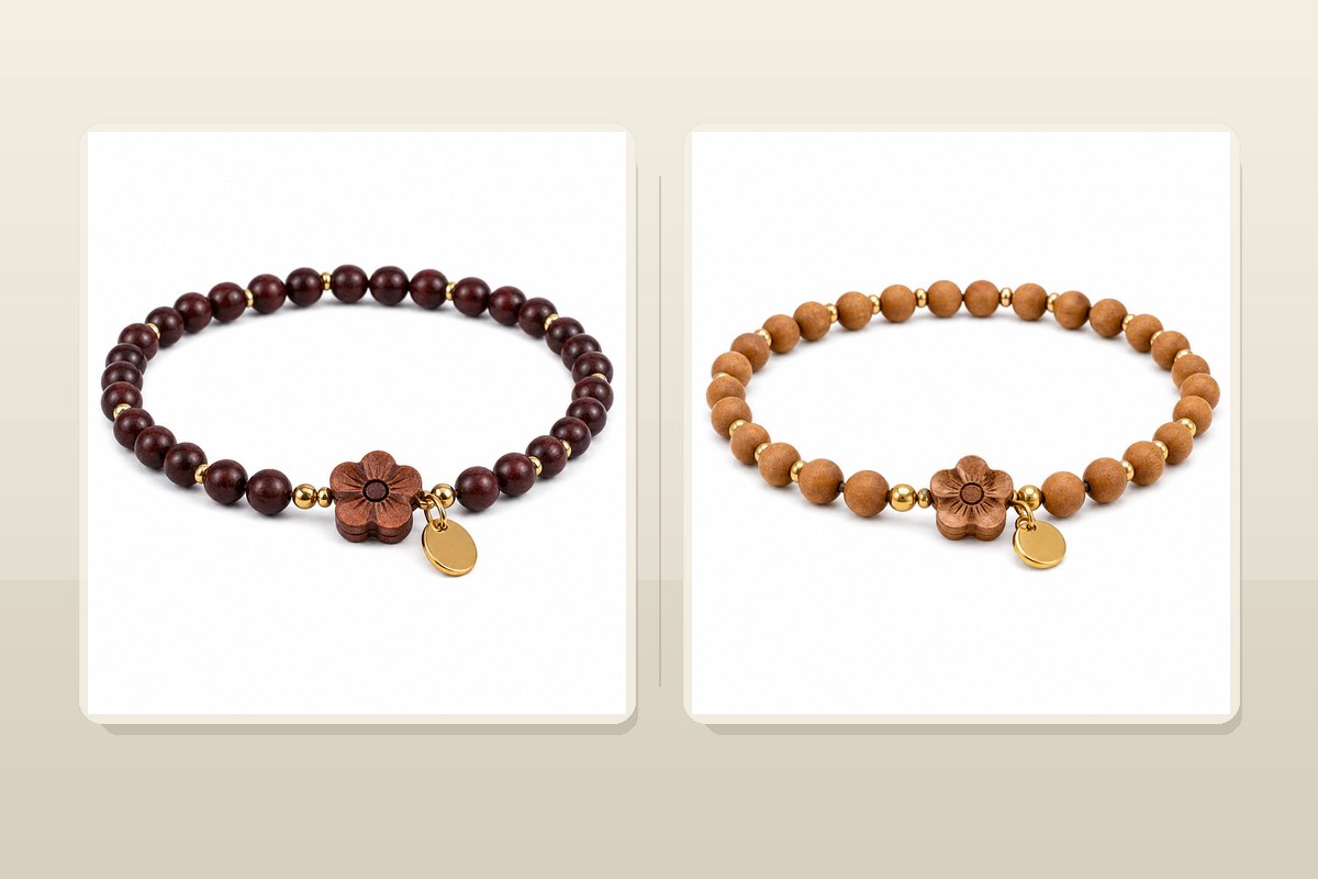 Dark wood bracelet and light sandalwood bracelet arranged together on warm neutral fabric
