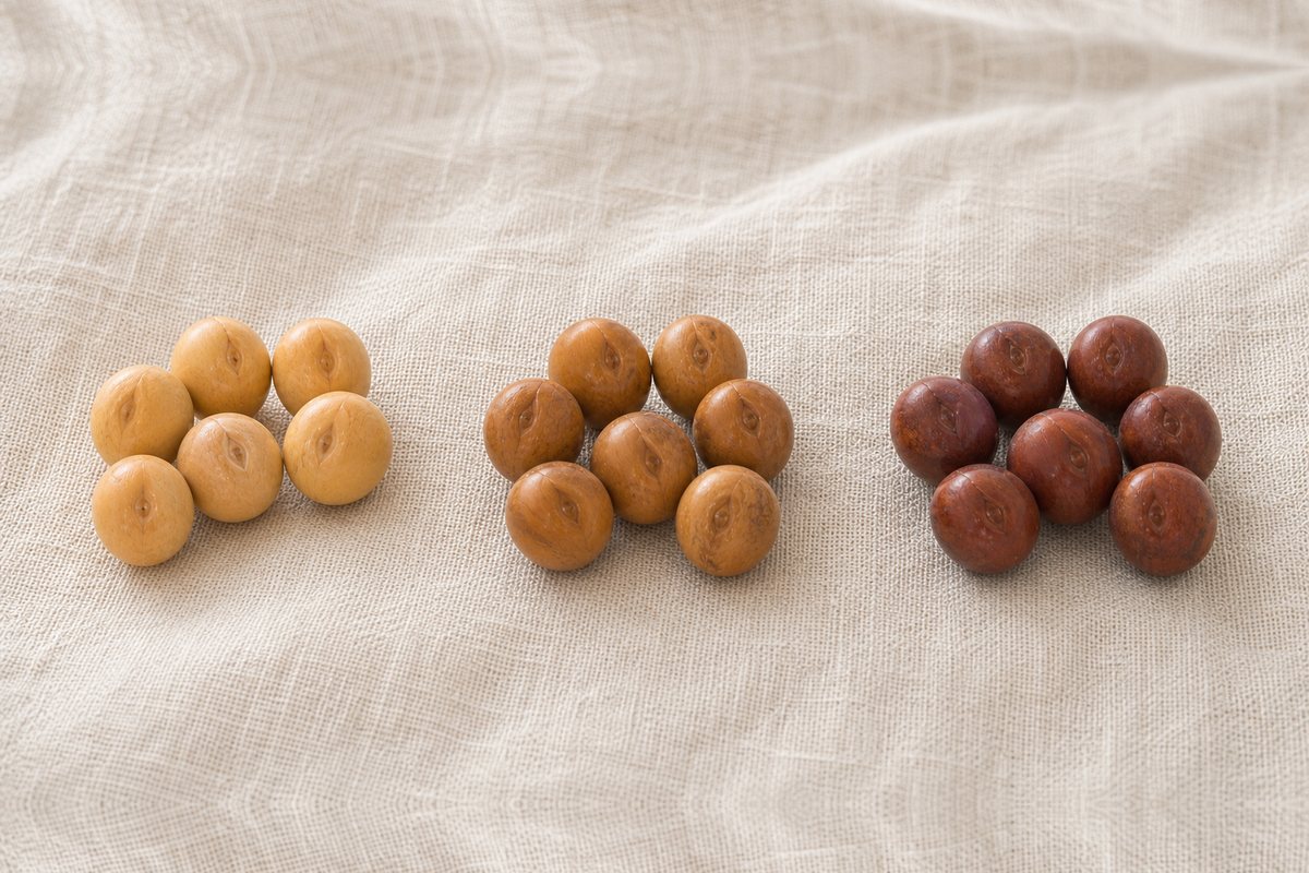 Three groups of Fengyan Bodhi beads showing pale ginger, honey, and natural oxford-red patina stages