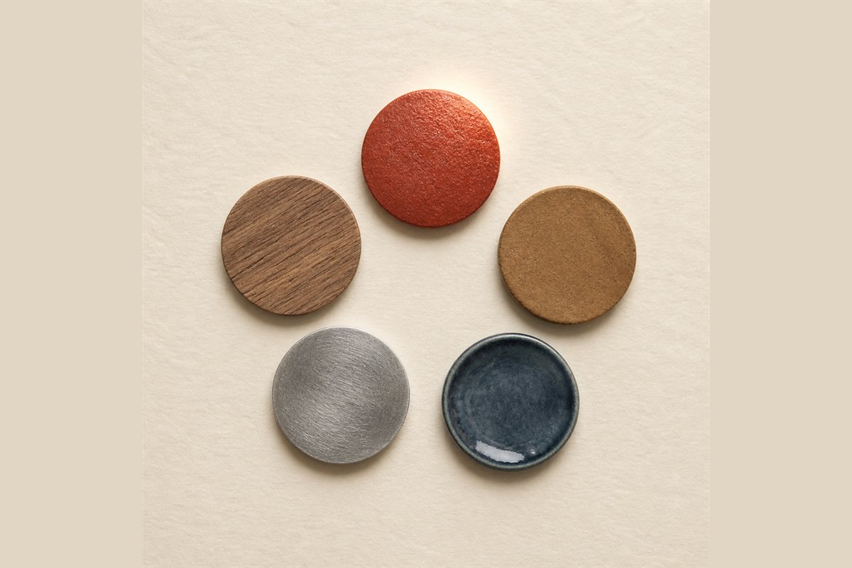 Five material swatches arranged in a circle with the ember-red swatch highlighted