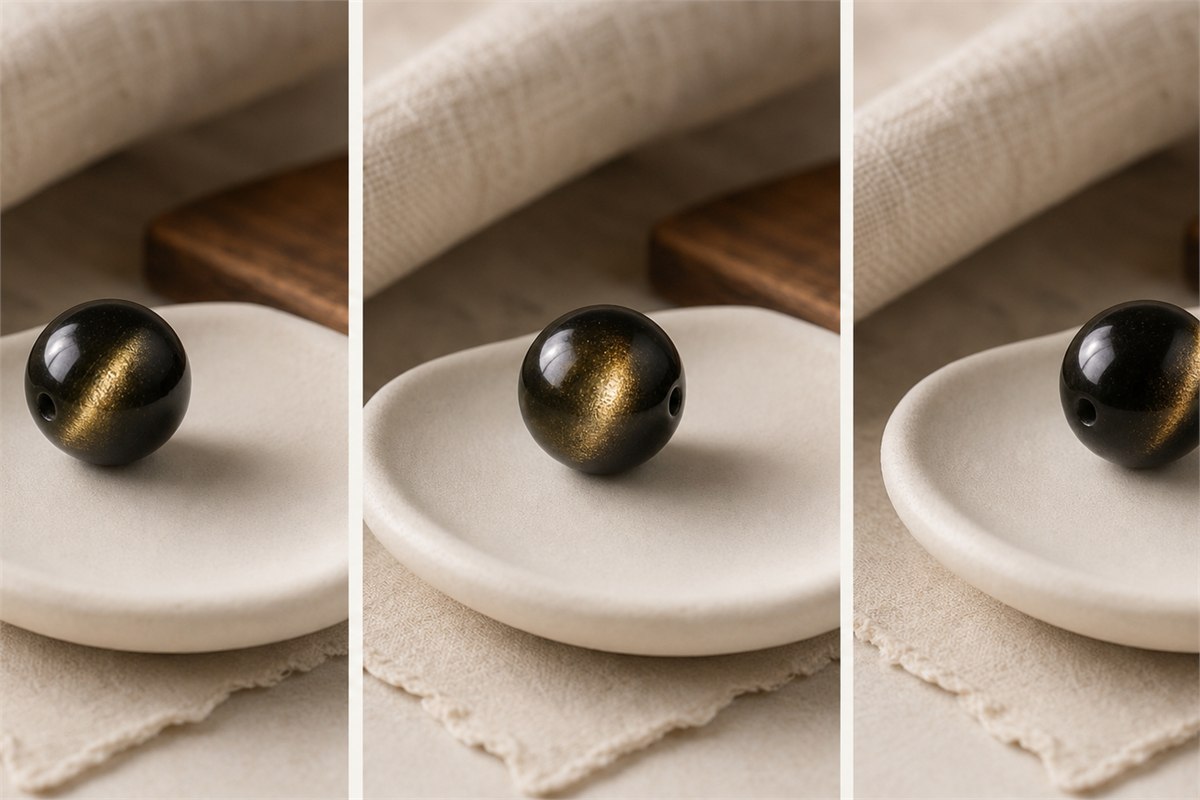 Same gold sheen obsidian bead at three rotations with the golden reflection moving across its surface