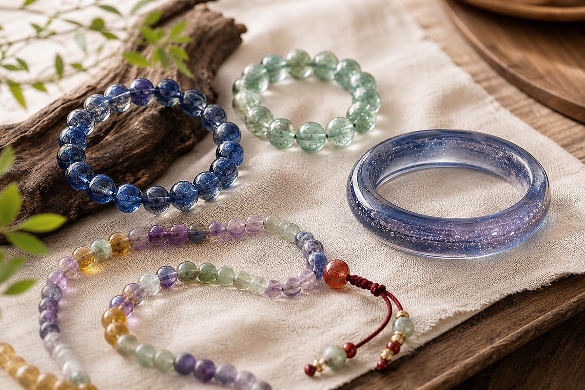 Close-up of Liuli bangle and beads showing translucent flowing color and jade-like softness