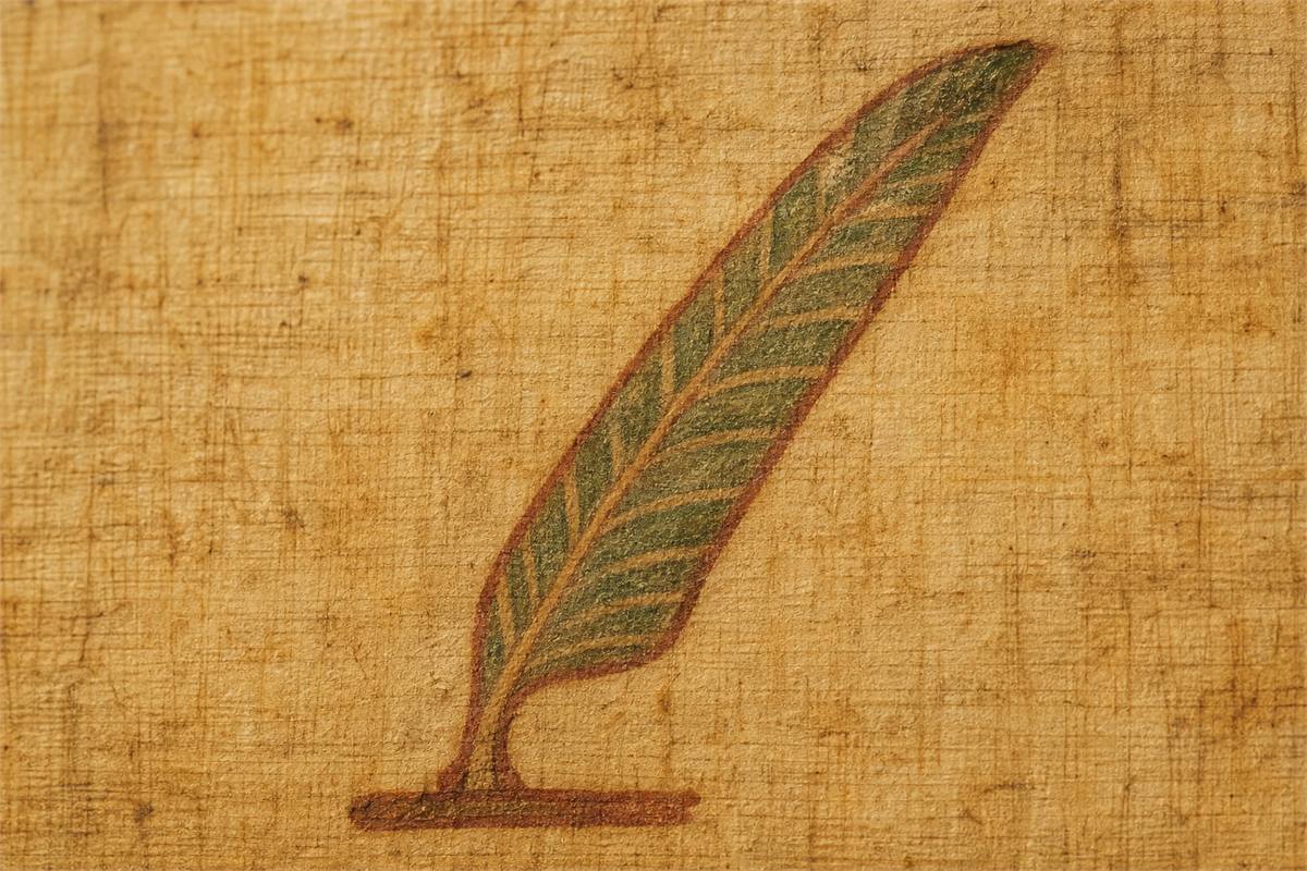 Close view of a single stylized Ma’at feather painted on an aged papyrus-like surface