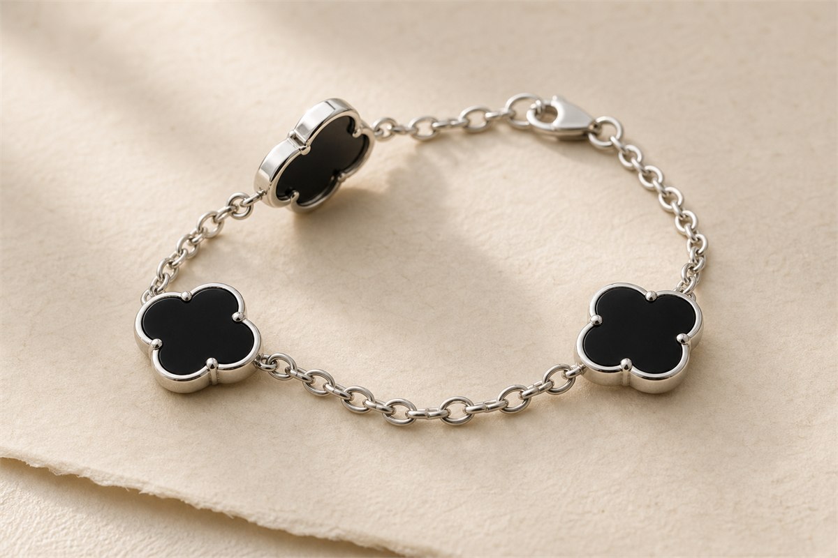 Generic black chalcedony quatrefoil settings showing bezel edges, solder joints, and clasp construction