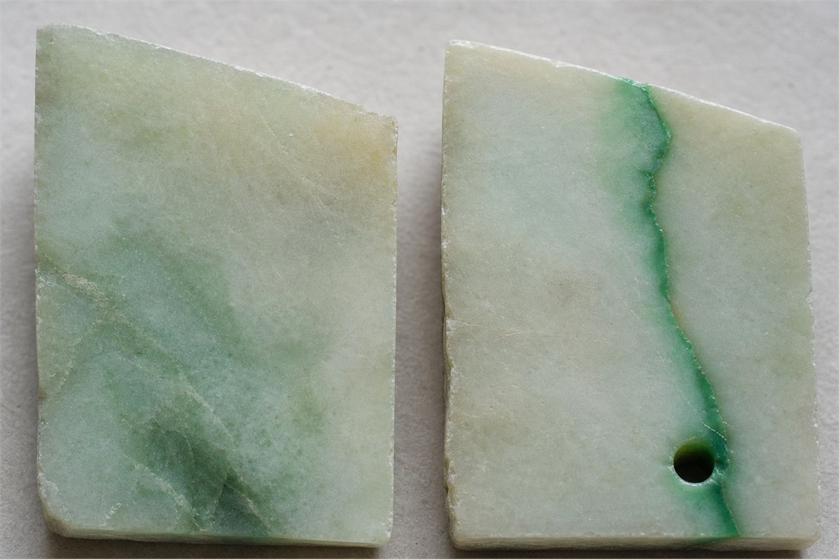 Two pale green stone samples showing gradual color and concentrated color along a fissure