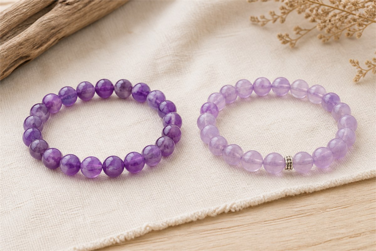 Medium-violet and pale-lavender amethyst bead bracelets with visible zoning, aligned holes, intact cord, and one silver spacer