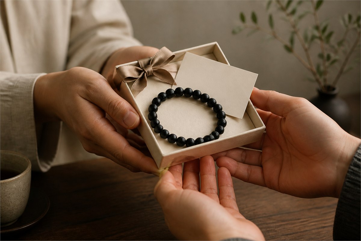 Black tourmaline bracelet offered in a warm ivory gift box with a blank card