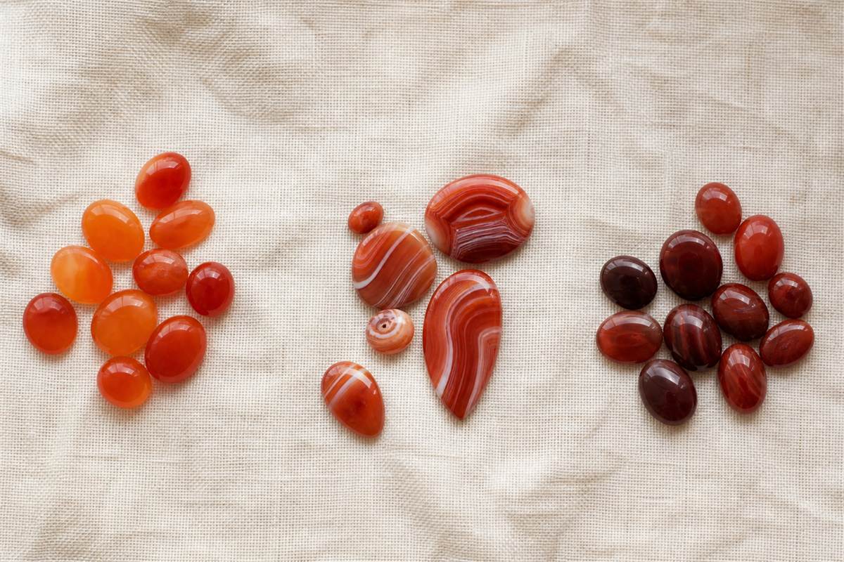 Separate groups of even orange-red carnelian, banded red agate, and darker brown-red sard