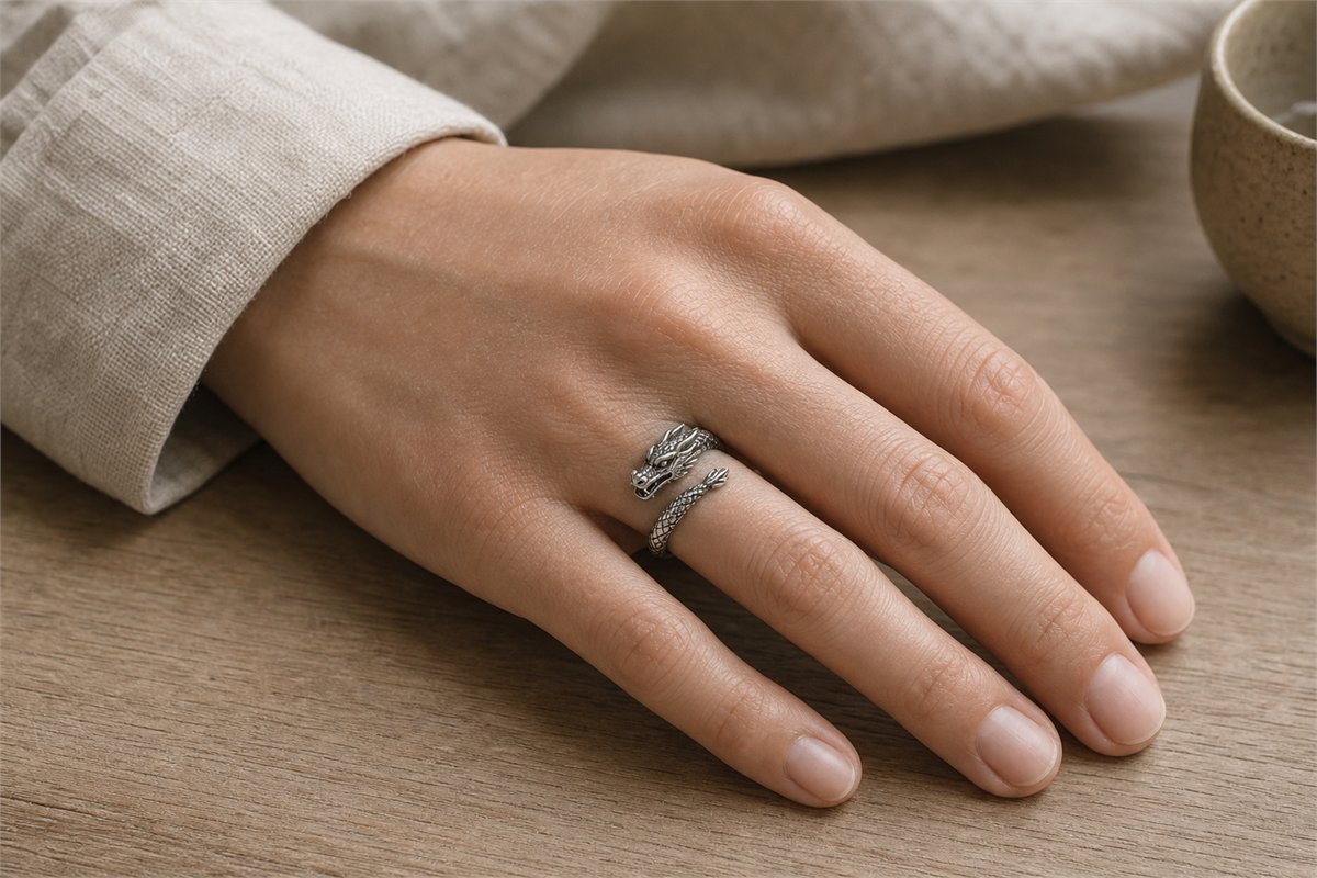 Silver dragon ring worn comfortably on the middle finger of a resting hand
