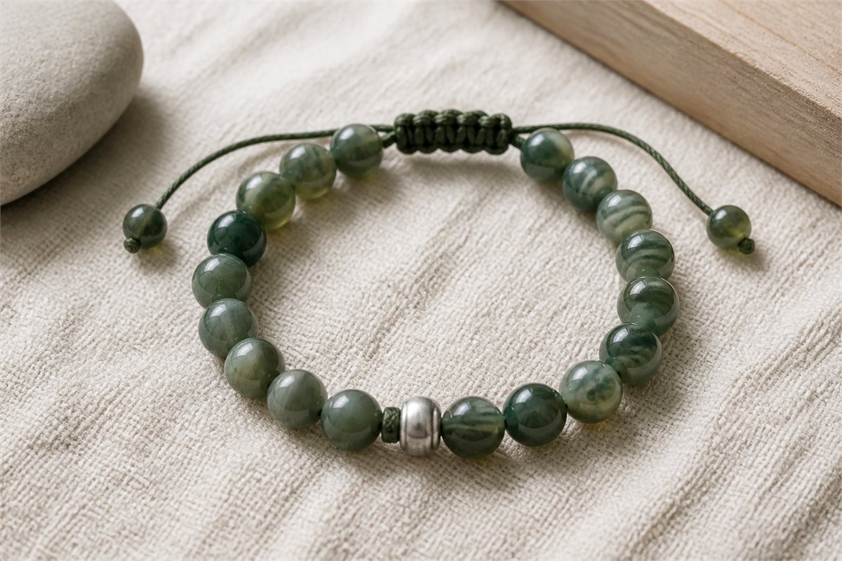 Green agate bead bracelet with continuous cord, adjustable macrame closure, and metal spacer
