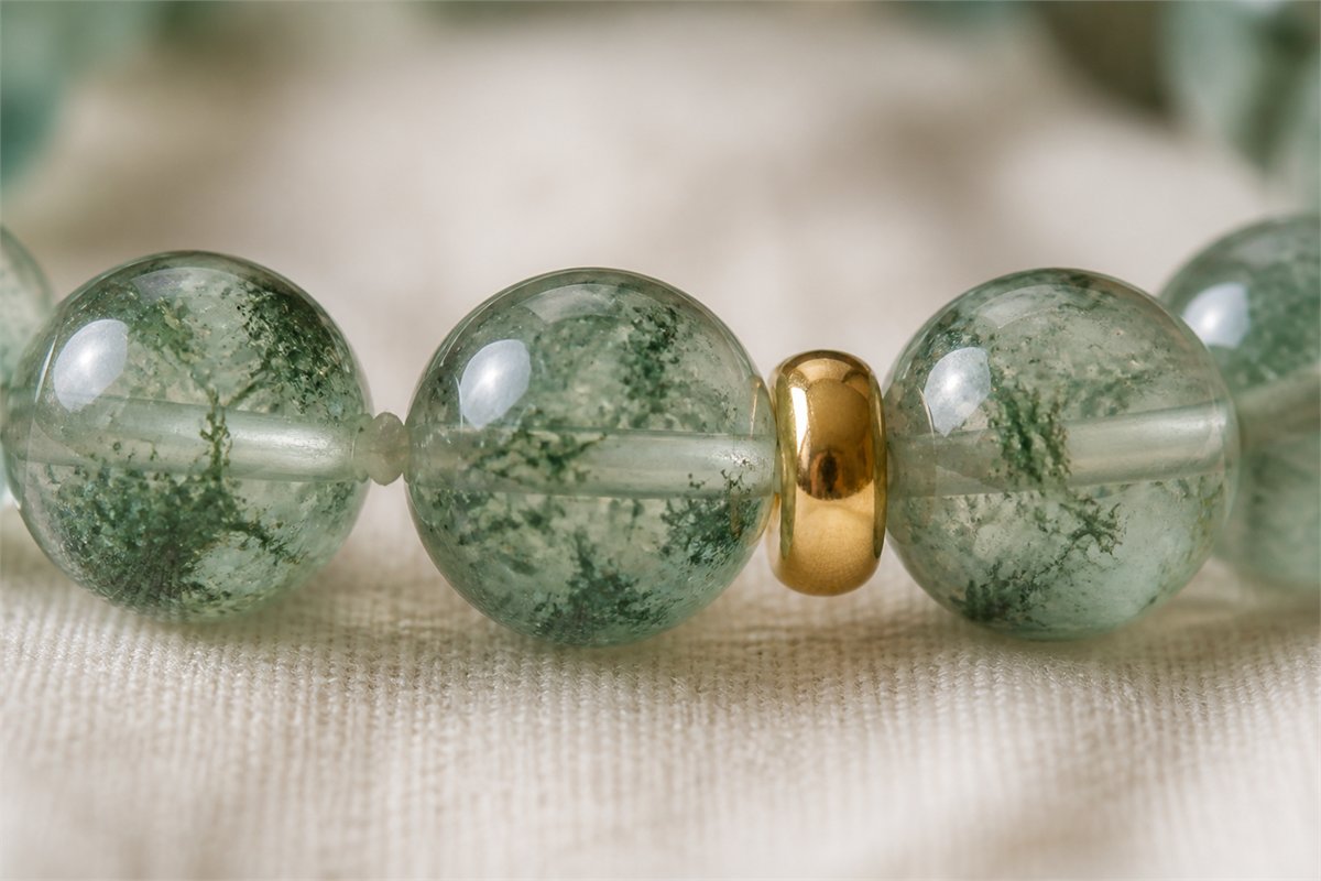 Macro view of green bracelet beads, continuous cord, and rounded gold-tone spacer