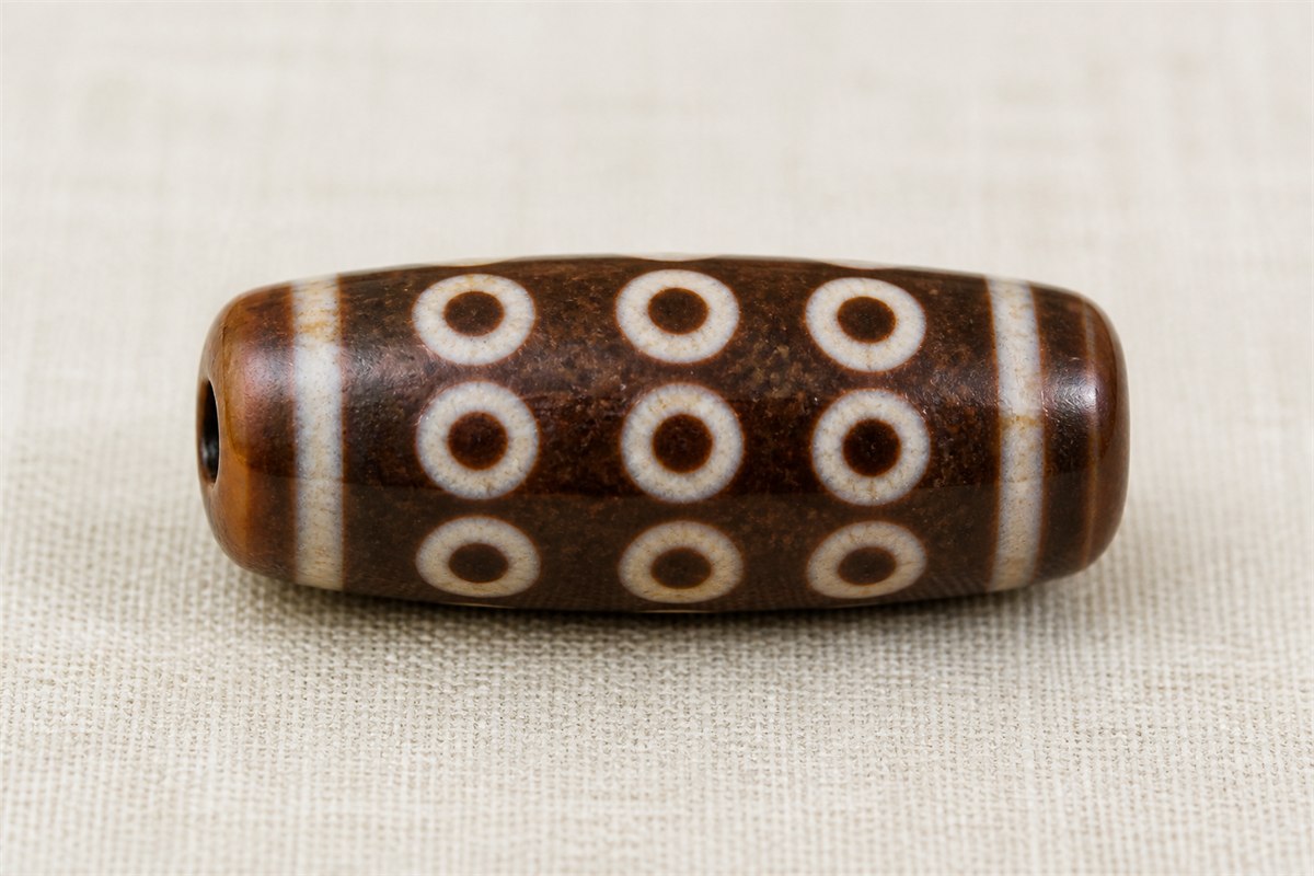 Single modern agate bead with exactly nine visible eye motifs arranged in three rows