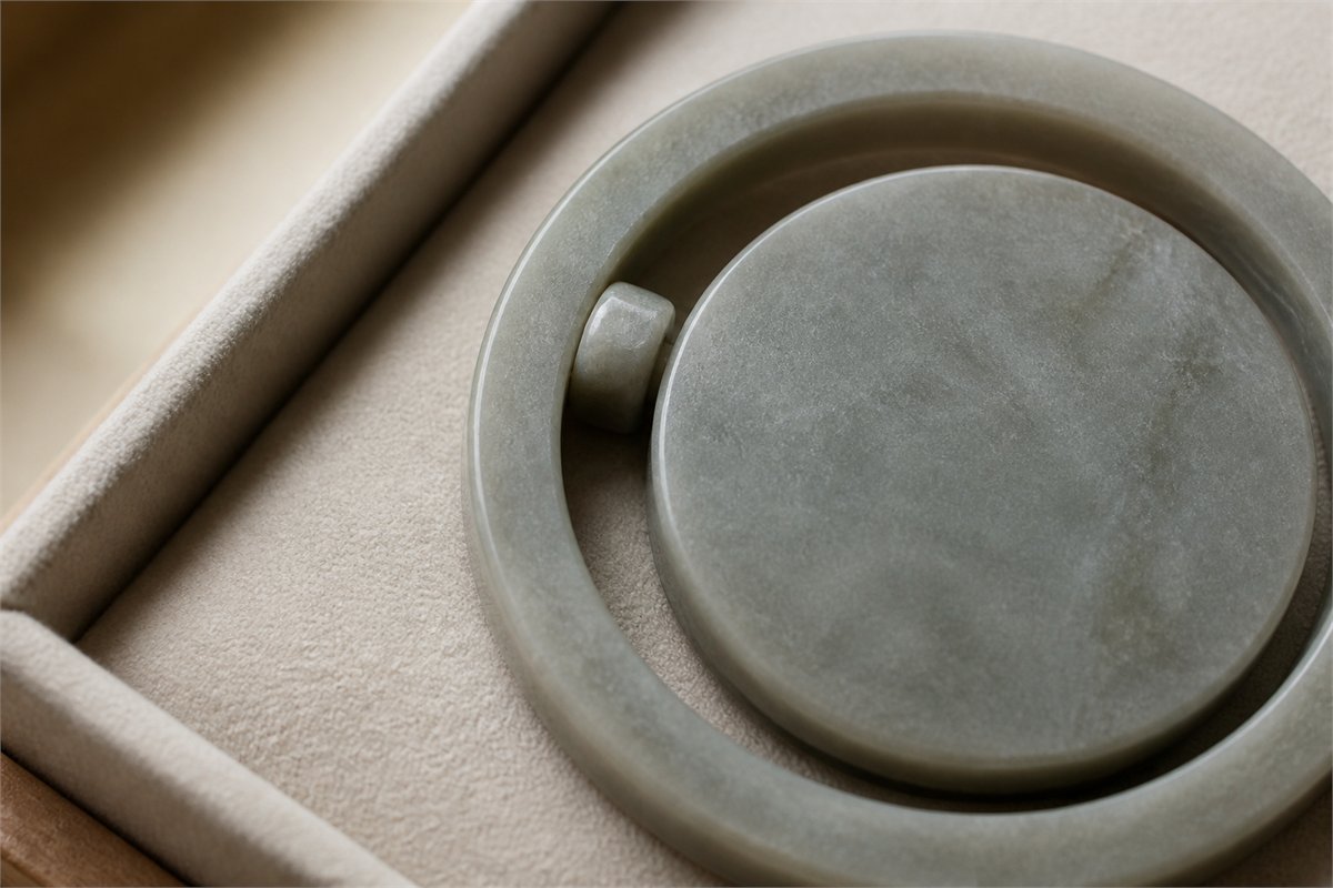 Close view of a stone-colored pendant pivot and the narrow gap around its movable center