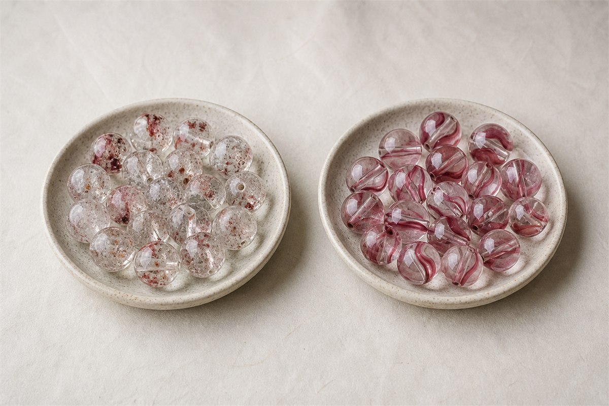 Included quartz beads beside cherry quartz glass beads with flowing pink-red swirls