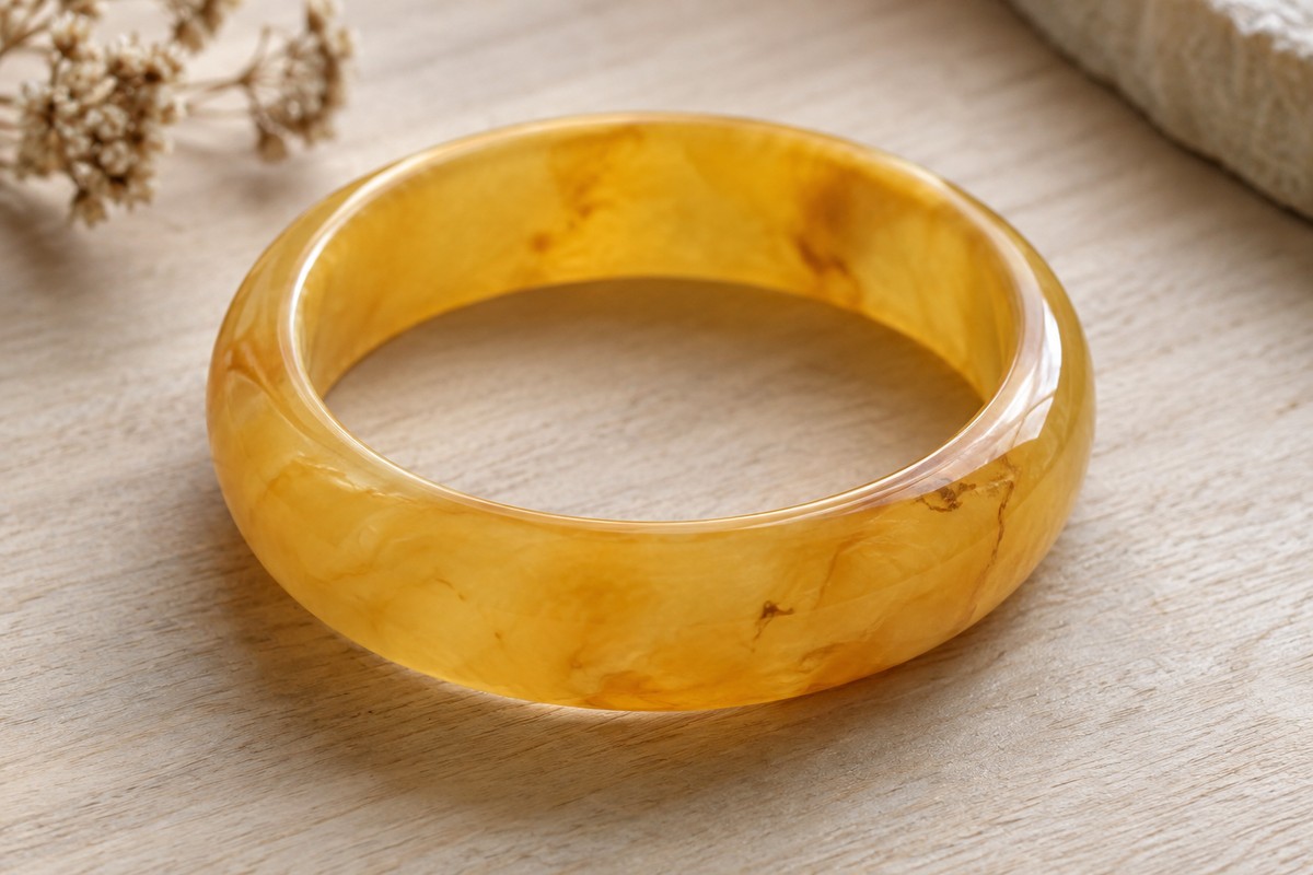 Solid cloudy amber bangle showing its inner opening and rounded edges