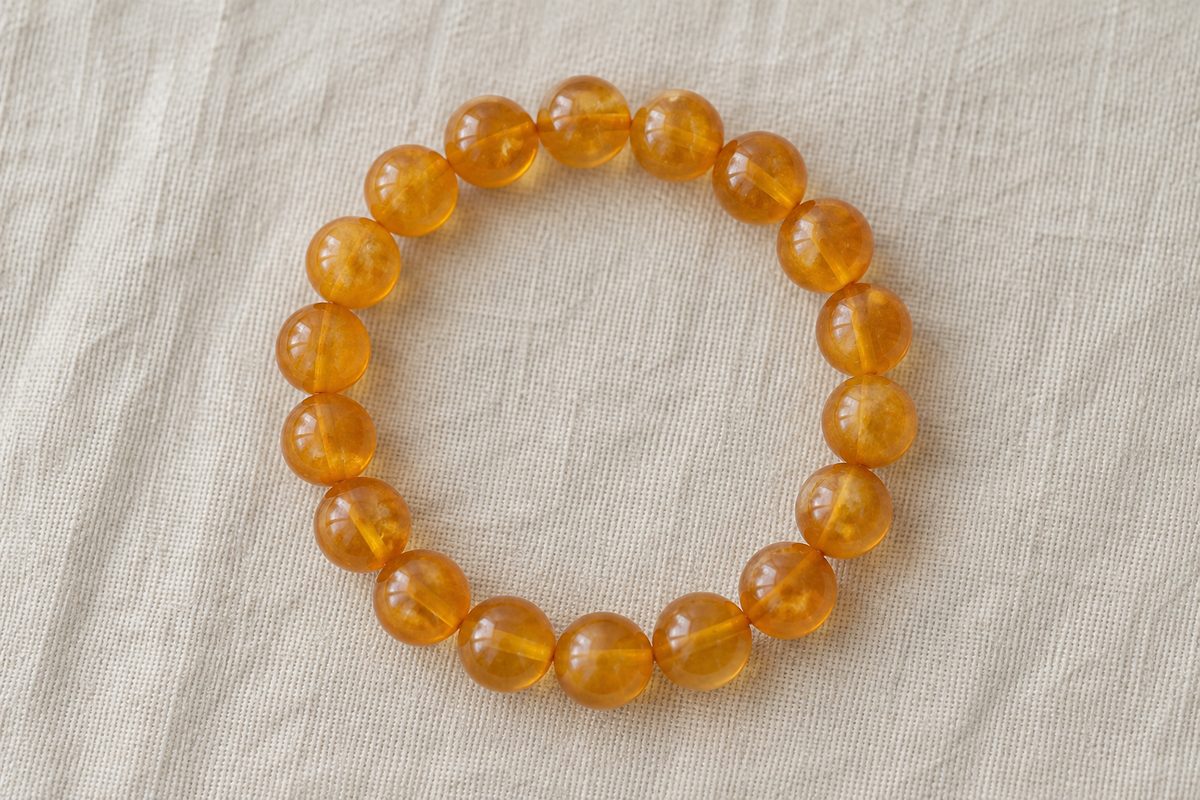 A complete round-bead bracelet lies flat with its inside opening visible.