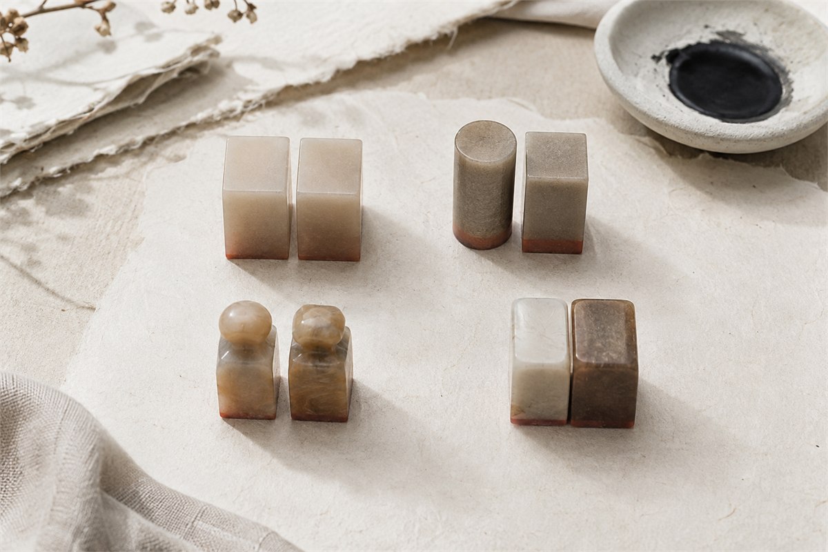 Two complementary stone seals with coordinated shapes on a studio table