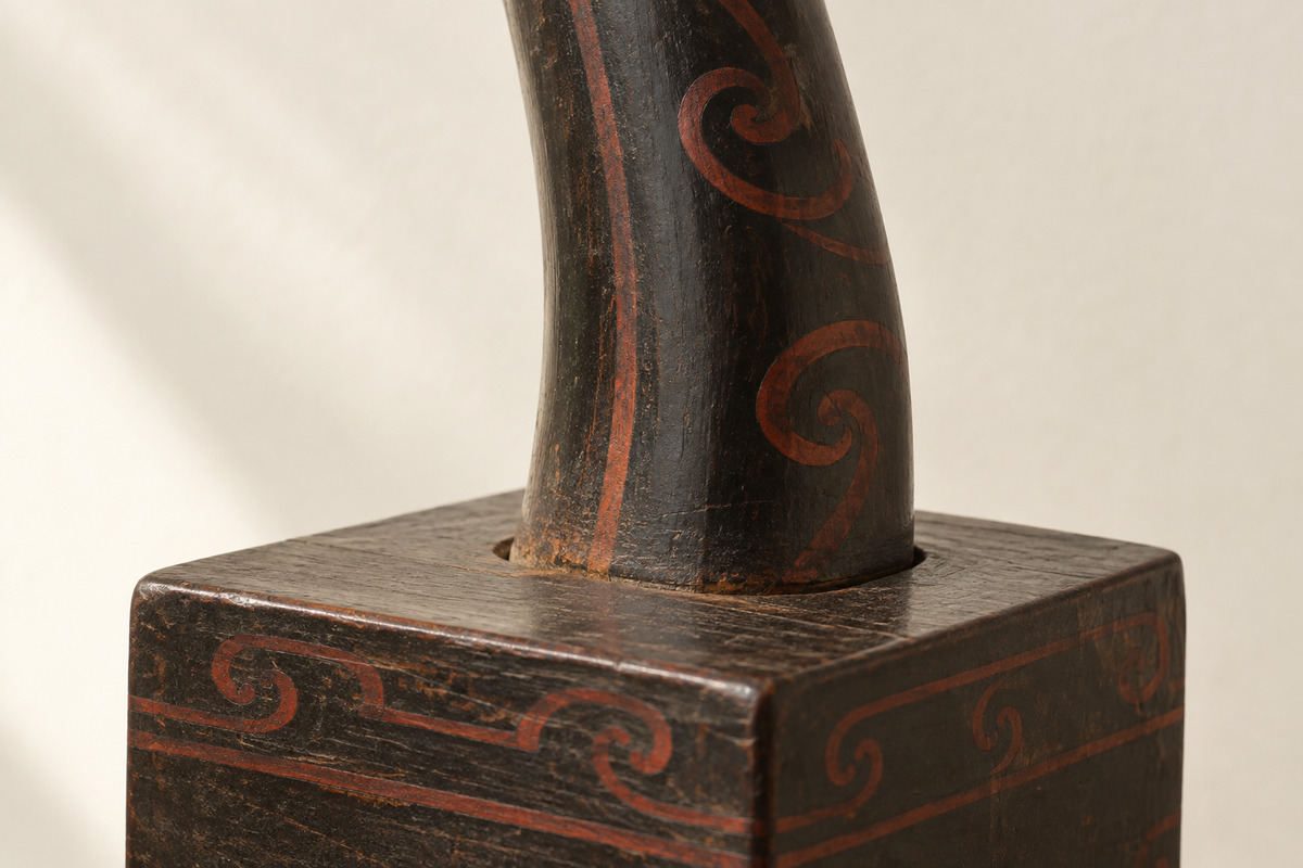 Joined wooden neck and base with red lacquer decoration