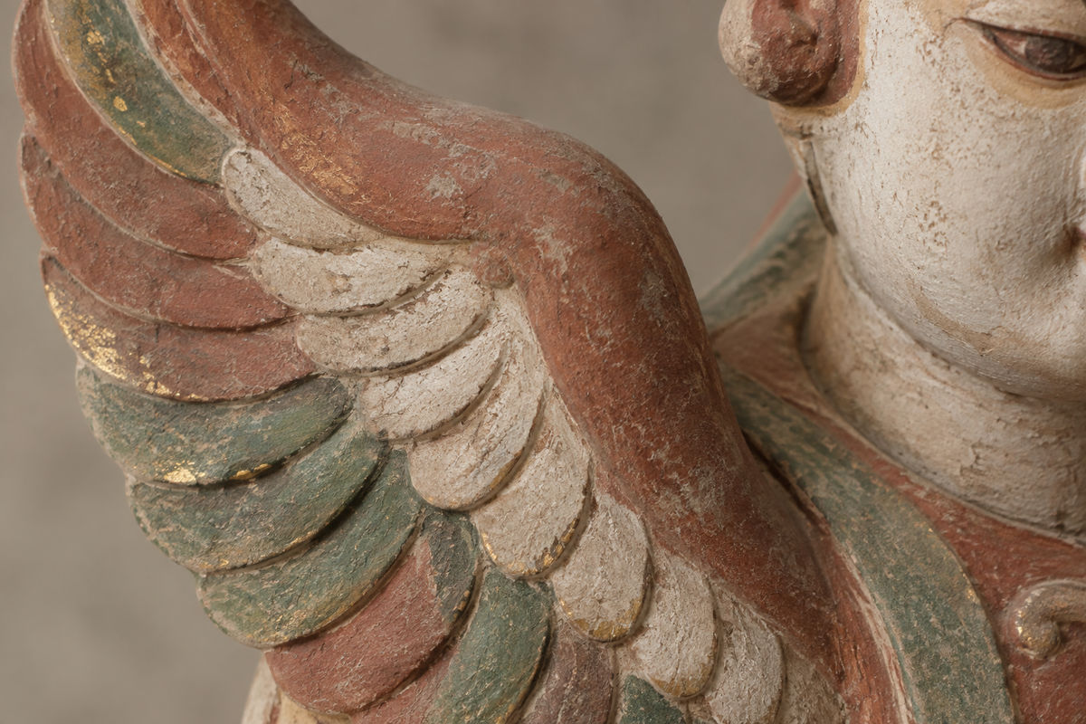 Matte painted clay wing with small gold-colored surface accents