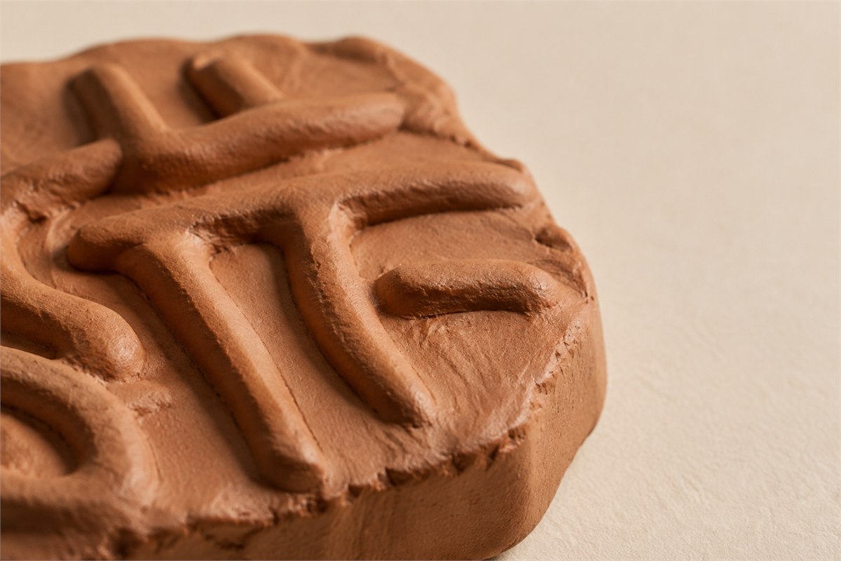 Modern clay impression with abstract raised ridges lit from the side