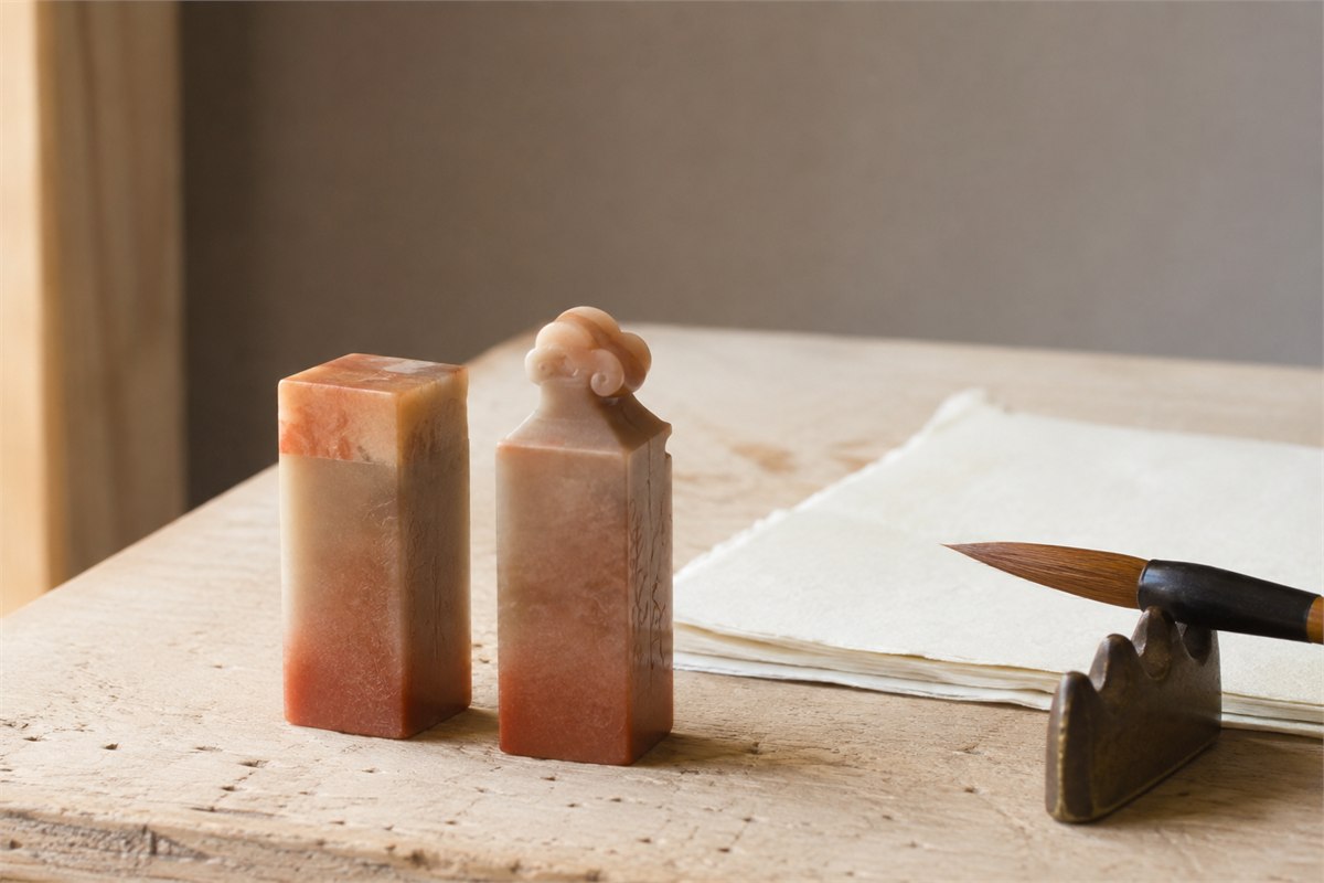 Two carved stone seal bodies viewed from the side under soft light